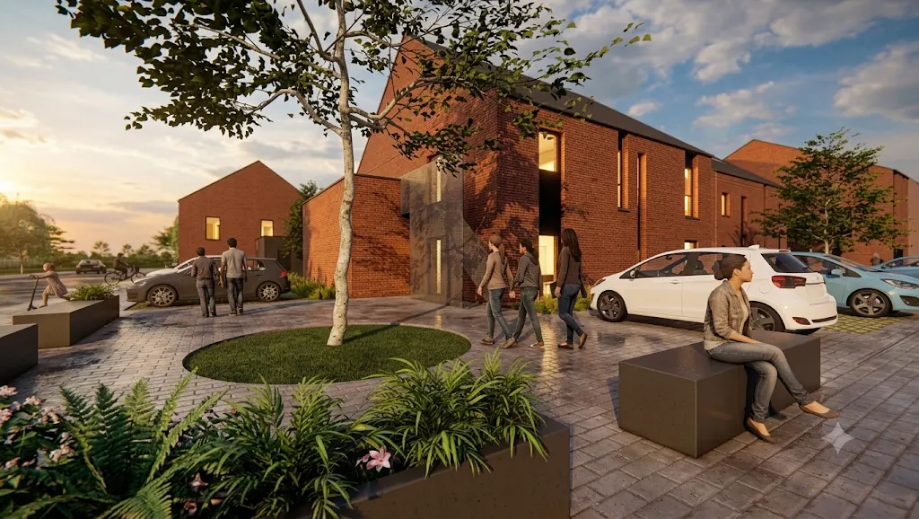 Cour plantée entre des maisons en brique rouge à toiture à deux versants, avec stationnement et bancs, à Jumet